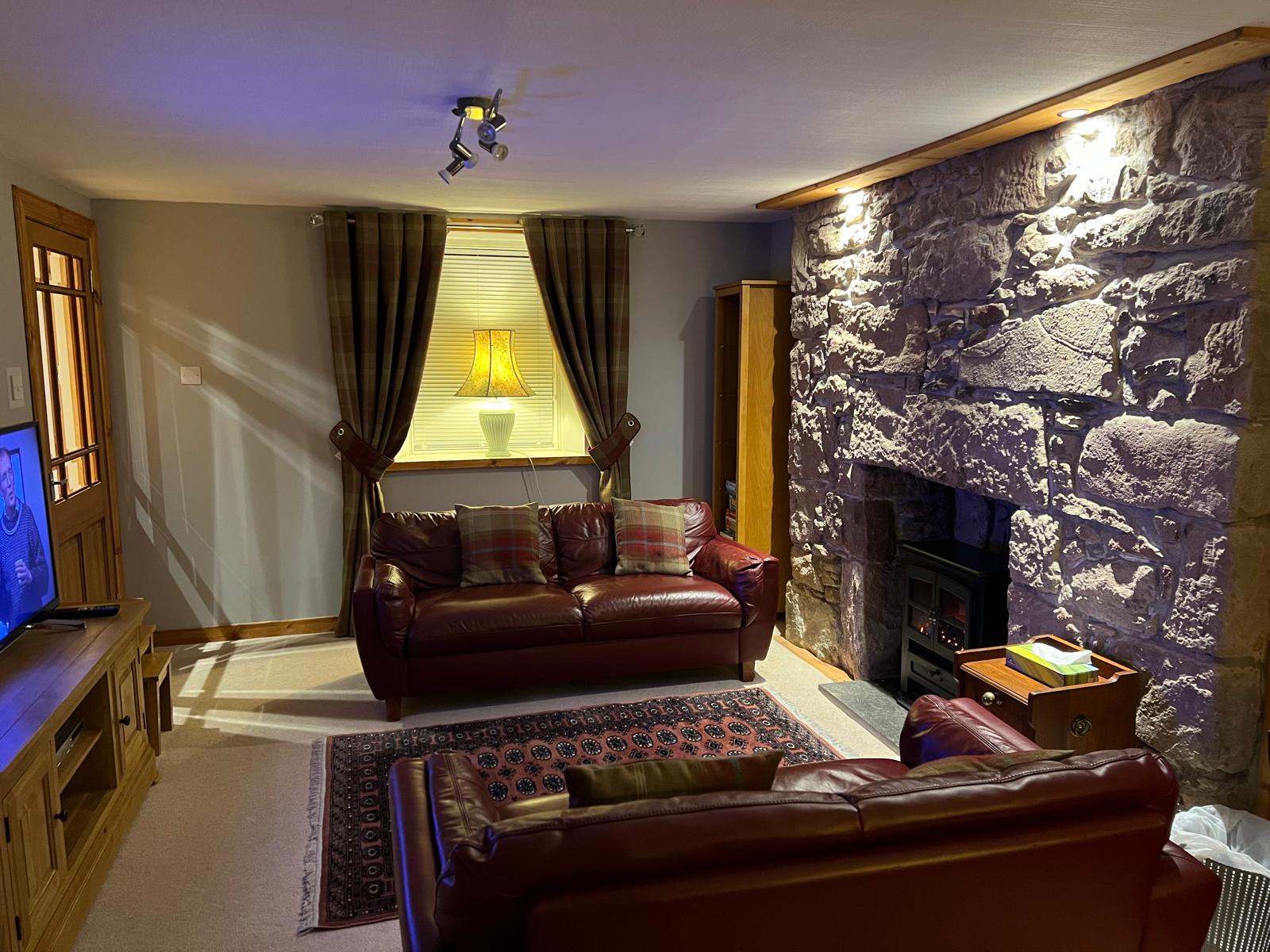 No.10 The Cottage living room with original stone fireplace